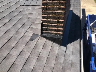 Installed roof vent with louvered design on asphalt shingle roof with flashing