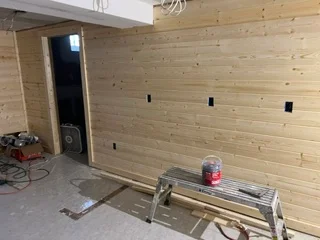 Pine wood wall framing with horizontal sheathing and electrical outlet boxes installed