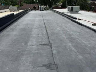 Flat roof membrane installation with seams and edge details