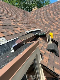Roof repair with shingle replacement and valley flashing installation on residential home