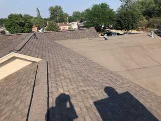 Newly installed asphalt shingle roof with architectural shingles and flashing on residential home
