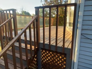 Composite deck with black metal railing and lattice panel detail