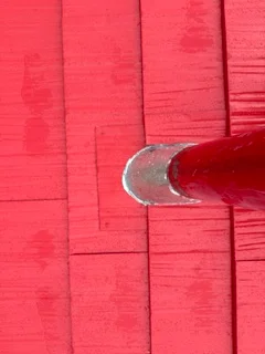 Red standing seam metal roof panels with fasteners and clean seams