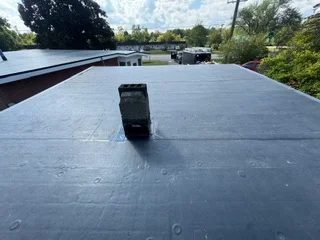 Flat roof membrane installation with seams and roof-mounted equipment