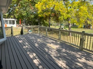 Composite deck with aluminum railings and board pattern, residential backyard